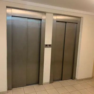 three elevator doors in a building with a tile floor at Hipólito Yrigoyen 150 in Cordoba