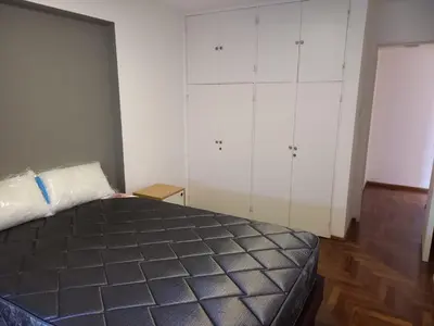a bedroom with a bed and white cabinets at Departamento 1 Dormitorio - Buenos Aires 1100 - Nueva Cordoba in Cordoba