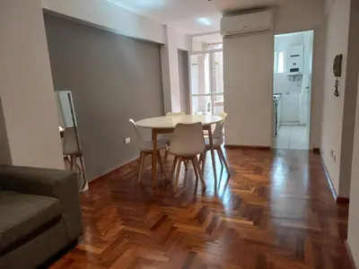 a living room with a dining room table and chairs at Departamento 1 Dormitorio - Buenos Aires 1100 - Nueva Cordoba in Cordoba