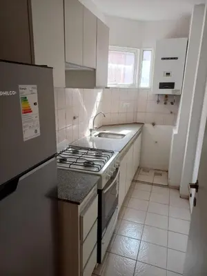 a white kitchen with a stove and a sink at Departamento 1 Dormitorio - Buenos Aires 1100 - Nueva Cordoba in Cordoba