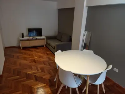 a white table and chairs in a room with a couch at Departamento 1 Dormitorio - Buenos Aires 1100 - Nueva Cordoba in Cordoba