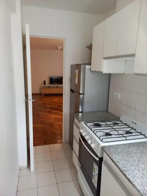 a kitchen with a stove and a refrigerator at Departamento 1 Dormitorio - Buenos Aires 1100 - Nueva Cordoba in Cordoba