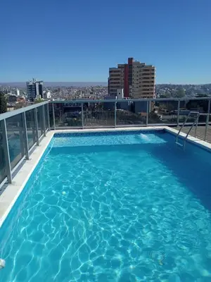 a swimming pool on the roof of a building at Departamentos NG CENTRO Carlos Paz in Villa Carlos Paz