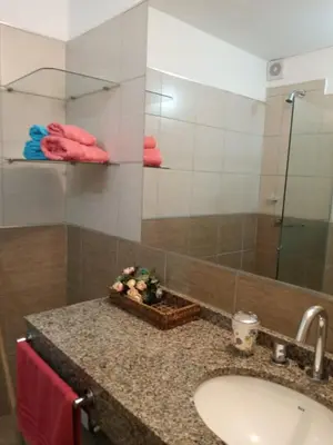 a bathroom counter with a sink and a mirror at Departamentos NG CENTRO Carlos Paz in Villa Carlos Paz