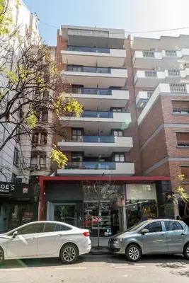 two cars parked in front of a building at Depto Familiar de dos habitaciones By Lofty in Cordoba