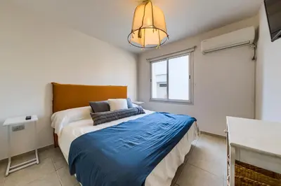 a bedroom with a large bed and a window at Viaggiato Obispo Salguero in Cordoba