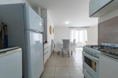 a kitchen with a white refrigerator and a stove at Viaggiato Obispo Salguero in Cordoba