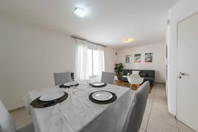 a dining room table with a white table cloth on it at Viaggiato Obispo Salguero in Cordoba