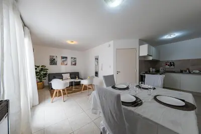 a dining room and kitchen with a table and chairs at Viaggiato Obispo Salguero in Cordoba
