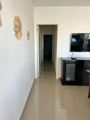 a hallway of a living room with a flat screen tv at Departamento amplio y muy iluminado en 9 piso, con piscina in Río Cuarto