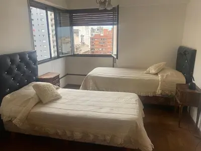 a hotel room with two beds and a window at Depto Boulevard Illia in Cordoba