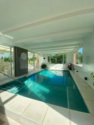 a large swimming pool with blue water in a house at Balcón de Nono in Nono