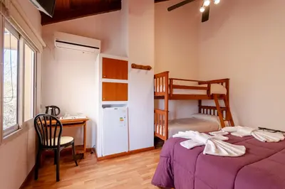 a bedroom with two beds and a desk and a bunk bed at Balcón de Nono in Nono