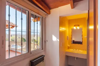 a bathroom with a sink and a window at Balcón de Nono in Nono