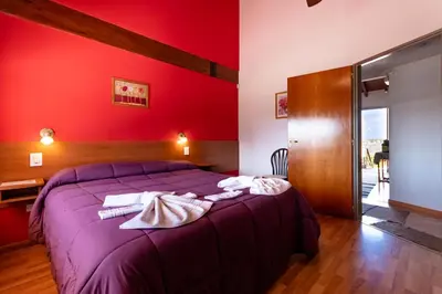 a bedroom with a purple bed with towels on it at Balcón de Nono in Nono