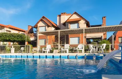 a house with a swimming pool in front of a house at Balcón de Nono in Nono