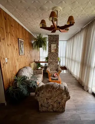 a living room with two couches and a ceiling fan at Hotel Ritz in Villa Carlos Paz