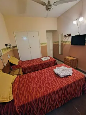 two beds in a hotel room with towels on them at Hotel Ritz in Villa Carlos Paz