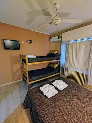 a room with two bunk beds and a ceiling at Hotel Ritz in Villa Carlos Paz