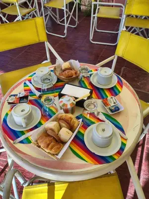 a table with bread and pastries on a colorful table cloth at Hotel Ritz in Villa Carlos Paz