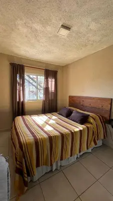 a large bed in a bedroom with a window at Calamuchita Alquileres in Santa Rosa de Calamuchita