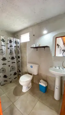 a bathroom with a toilet and a sink at Calamuchita Alquileres in Santa Rosa de Calamuchita