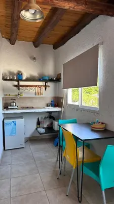 a kitchen with a table and chairs in a room at Calamuchita Alquileres in Santa Rosa de Calamuchita