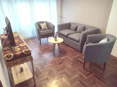 a living room with a couch and a table at Depto Plaza España in Cordoba
