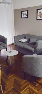 a living room with a couch and a table at Depto Plaza España in Cordoba
