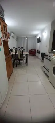 a kitchen with a table and chairs and a refrigerator at Fantástico Dpto Av Maipu 518 in Cordoba