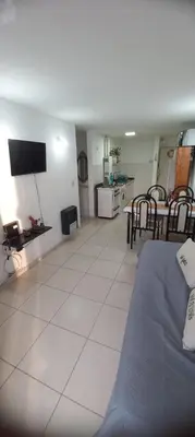 a living room with a blue couch and a kitchen at Fantástico Dpto Av Maipu 518 in Cordoba