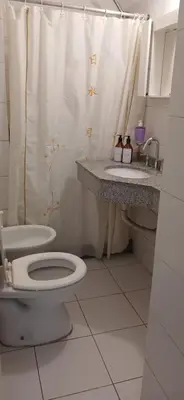 a bathroom with a toilet and a shower curtain at Fantástico Dpto Av Maipu 518 in Cordoba