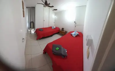 a room with two beds and a red blanket at Fantástico Dpto Av Maipu 518 in Cordoba