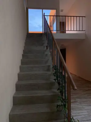 a staircase in a house with a glass window at Cañas Suites Villa Cura Brochero in Villa Cura Brochero