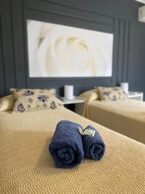 a pair of towels sitting on top of two beds at Cañas Suites Villa Cura Brochero in Villa Cura Brochero