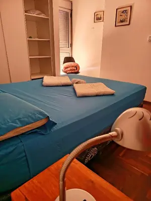a bed with blue sheets and pillows on it at Paraná Terrazas Nva Cordoba in Cordoba