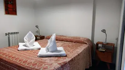 a hotel room with two beds with towels on them at Paraná Terrazas Nva Cordoba in Cordoba