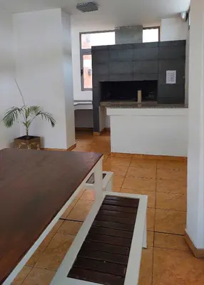 a living room with a table and a fireplace at Paraná Terrazas Nva Cordoba in Cordoba
