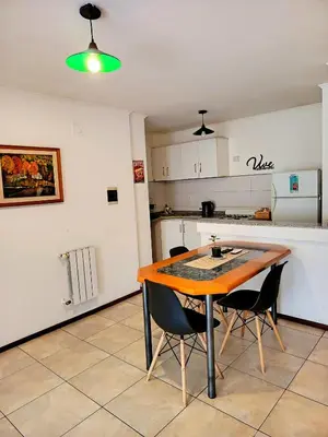 a kitchen with a wooden table and two chairs at Paraná Terrazas Nva Cordoba in Cordoba