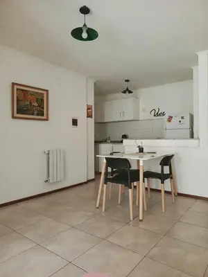 a kitchen with a table and chairs in a room at Paraná Terrazas Nva Cordoba in Cordoba