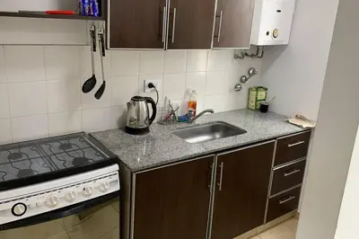 a small kitchen with a sink and a stove at Moderno Departamento Acogedor in Cordoba