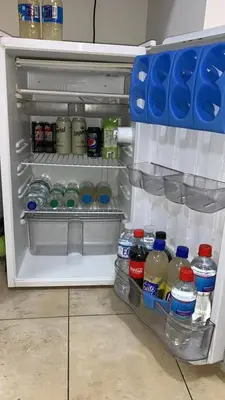 an open refrigerator filled with lots of bottles of water at Moderno Departamento Acogedor in Cordoba