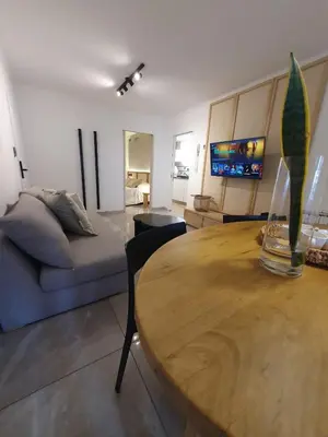 a living room with a wooden table and a couch at LOAN Nueva Cordoba categoría appart 11B in Cordoba