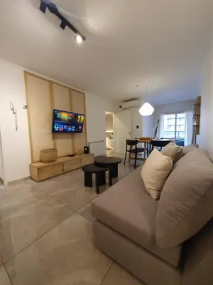 a living room with a couch and a dining room at LOAN Nueva Cordoba categoría appart 11B in Cordoba