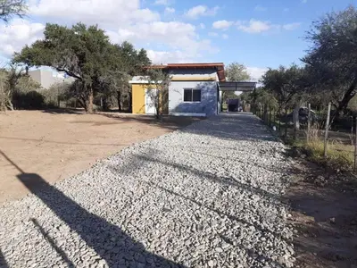 a gravel road in front of a building at La casita de Emilia in Los Molles