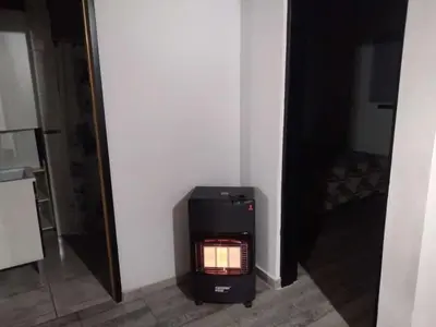 a stove in the corner of a room at La casita de Emilia in Los Molles