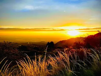 a sunset on the top of a hill with grass at Depto Av del Sol in Merlo