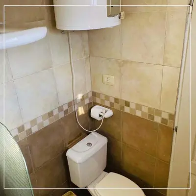 a small bathroom with a toilet and a sink at Depto Av del Sol in Merlo