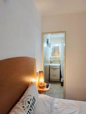 a bedroom with a bed and a table with a lamp at Depto Av del Sol in Merlo