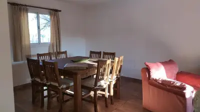 a dining room with a table and chairs and a couch at Indigo in Carpintería